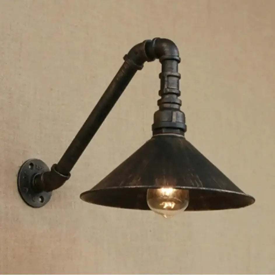 Decorbites™ farmhouse style wall sconce with antique brass cone and dark rustic metal pipe fittings for dining room lighting