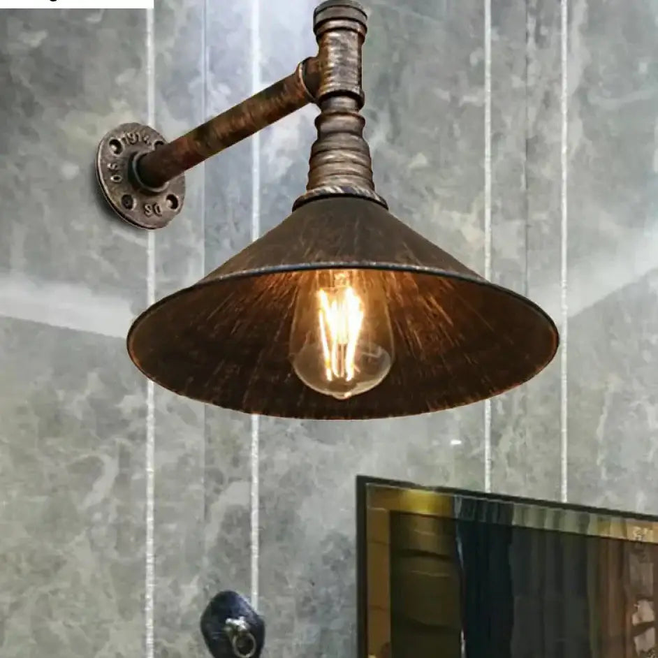 DecorBites™ farmhouse style wall sconce with antique brass cone and pipe arm featuring exposed filament bulb