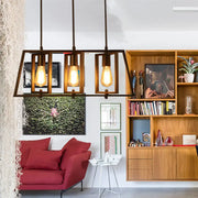 DecorBites™ farmhouse trapezoid frame island pendant light with three exposed Edison bulbs in black metal frame