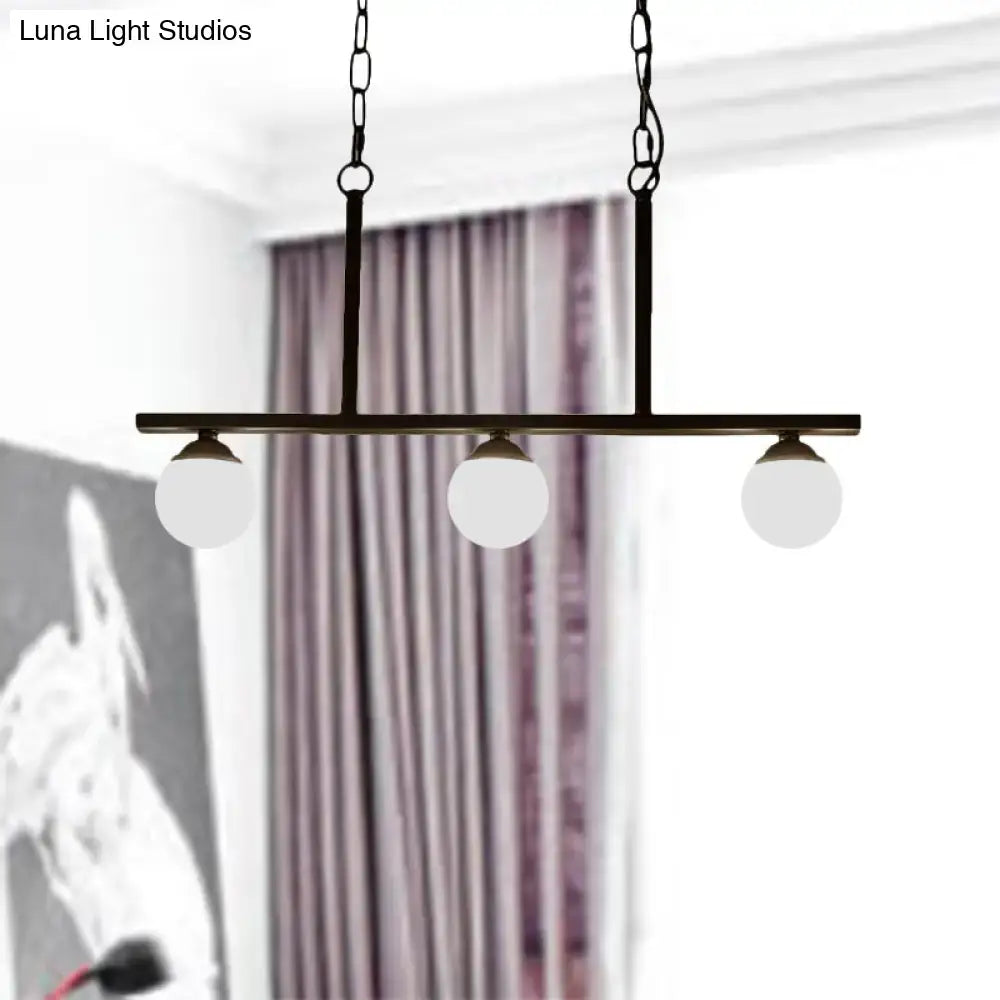 Black metal bar pendant light with three opal glass globe shades ideal for dining rooms by DecorBites™