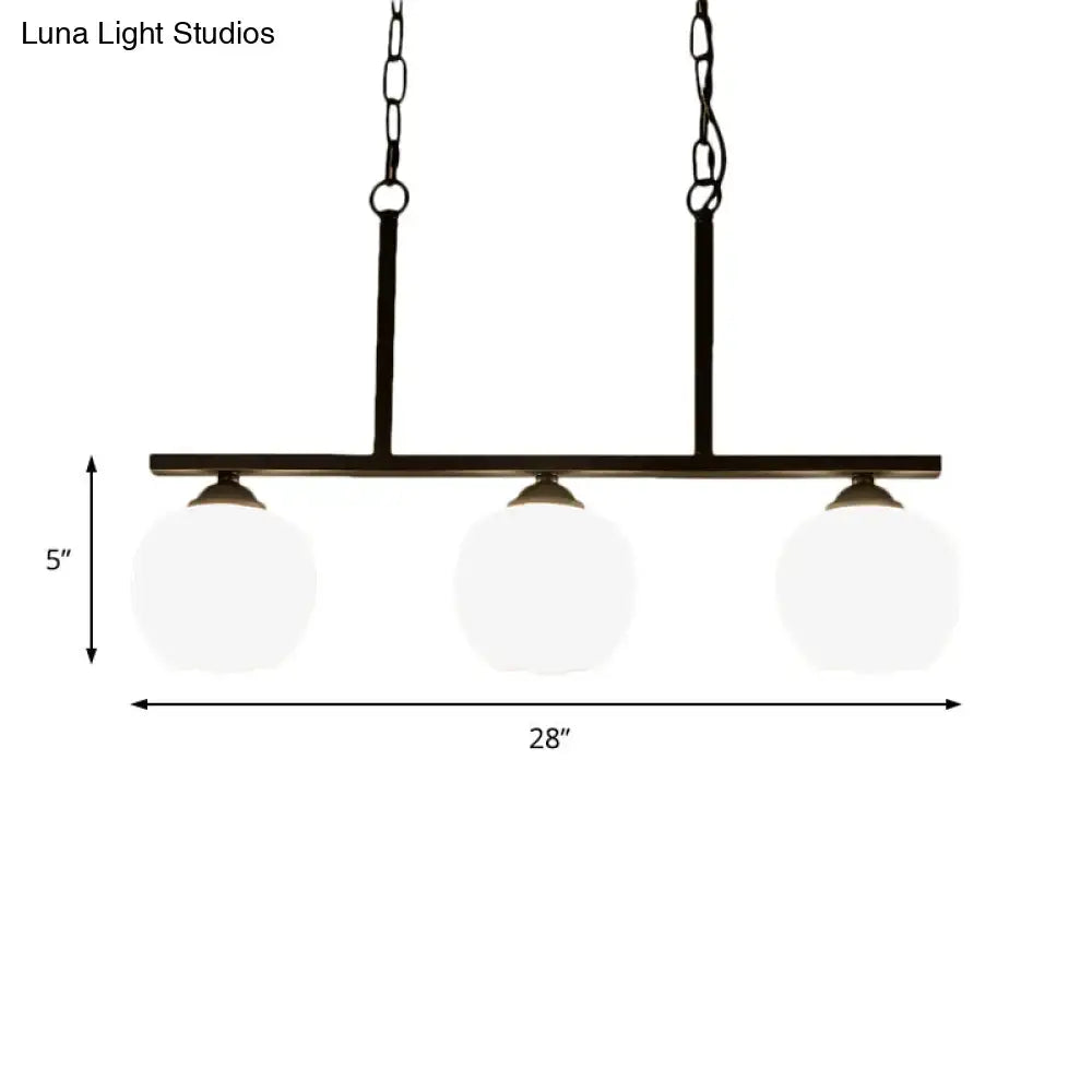 Black metal bar pendant light with three opal glass globe shades ideal for dining rooms by DecorBites™