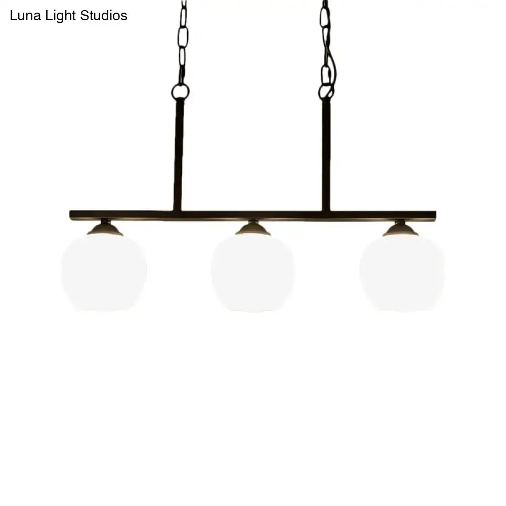 Black metal pendant light with three opal glass globe shades ideal for dining room lighting by DecorBites™