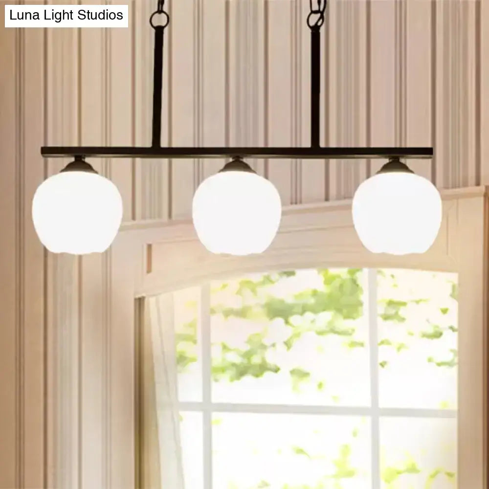 Black metal bar pendant light with three frosted opal glass globe shades perfect for dining rooms decorbites industrial lighting