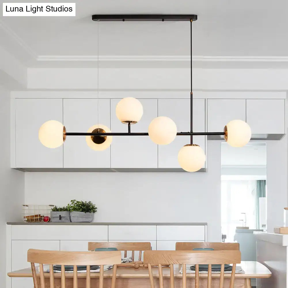 Modern black metal 6-light island pendant with frosted amber milky white glass globe lights and adjustable cord