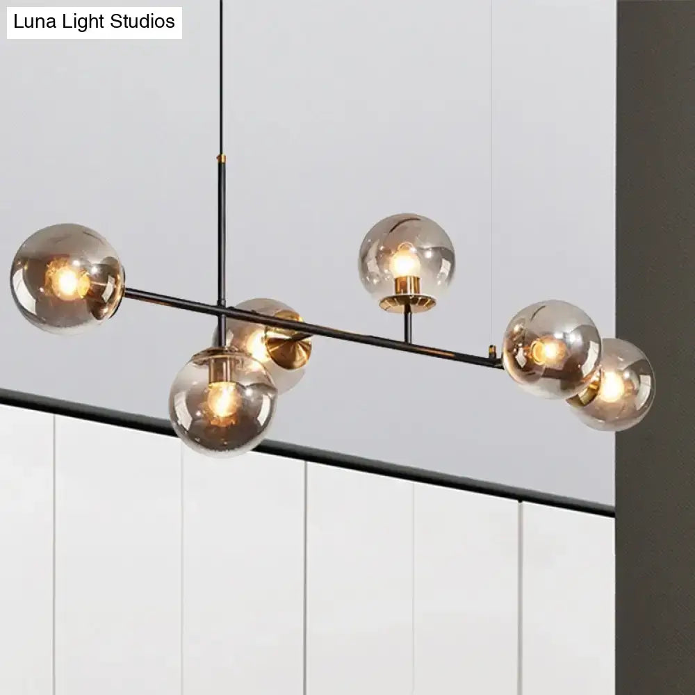 Modern black metal 6-light island pendant with amber milky white smoked glass globes and brass accents hanging fixture