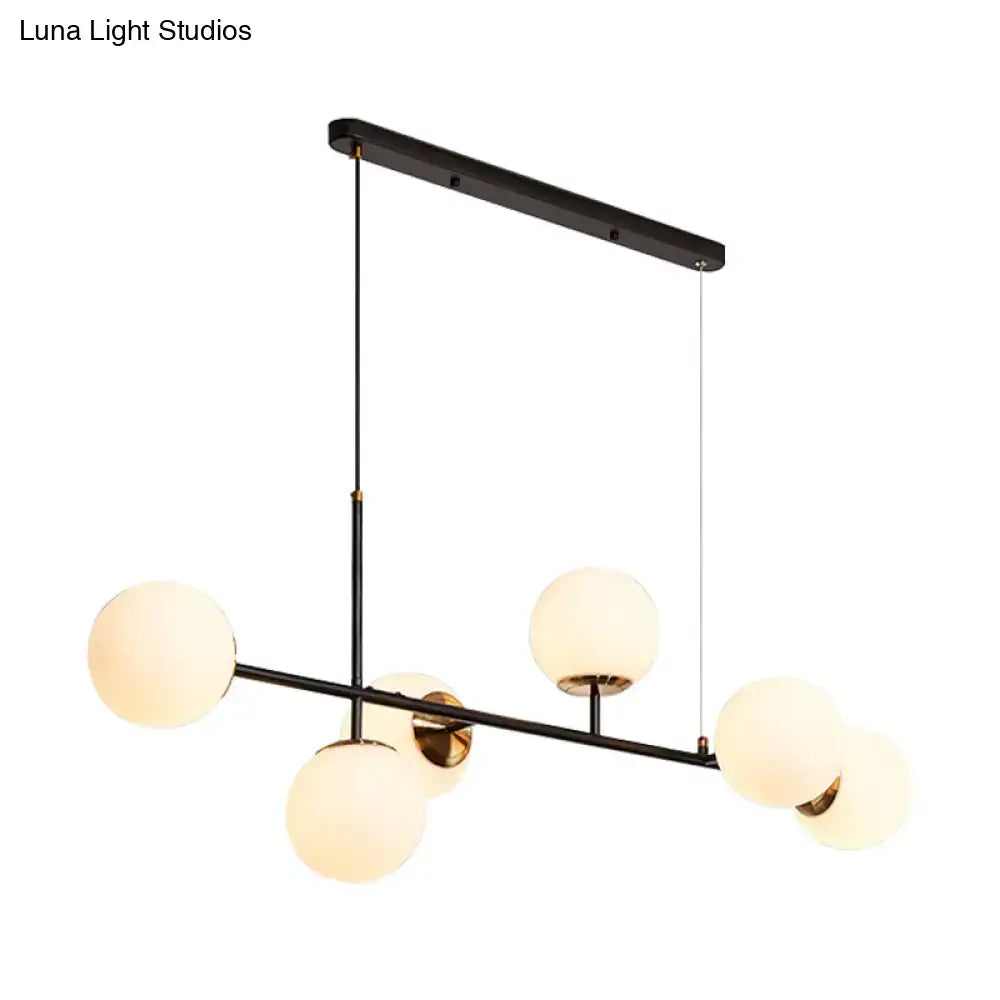 Modern black metal 6-light island pendant with frosted glass globes and amber milky white gradient shades