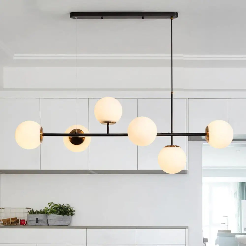 Modern black metal 6-light island pendant with frosted glass globe bulbs and amber milky white gradient shades