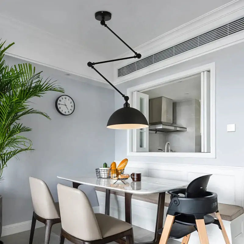 Black industrial pendant light with adjustable long arm and dome-shaped shade for living room lighting