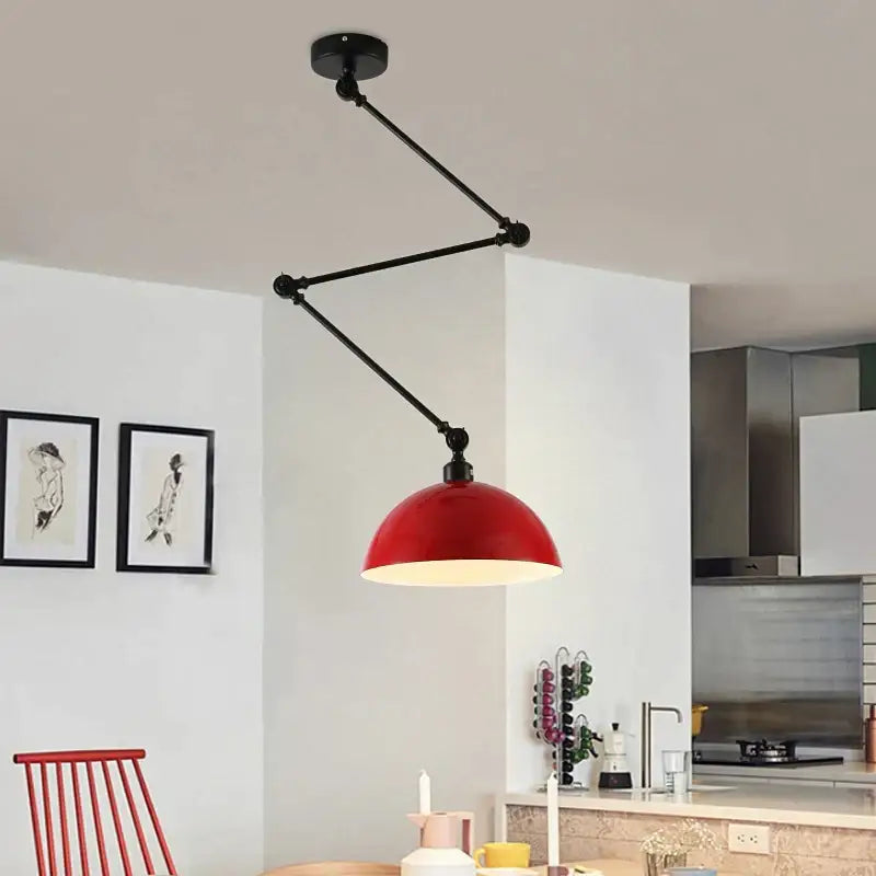 Industrial black adjustable long arm pendant light with red dome shade and black articulated arms for living room