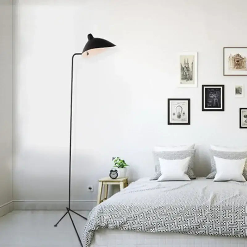 Black floor lamp with adjustable spider arm and sleek curved neck on tripod base for industrial decorbites lighting