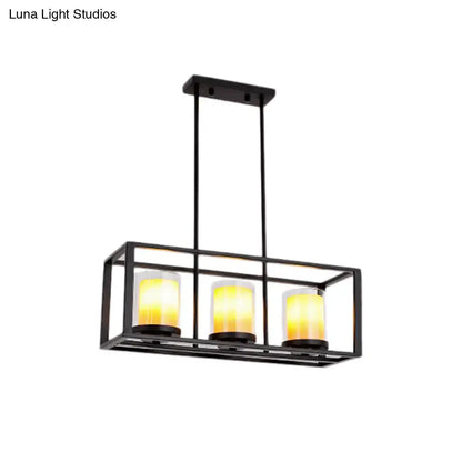 Black metal rectangular light fixture with three warm yellow glass candle bulbs for amber cylinder island lighting