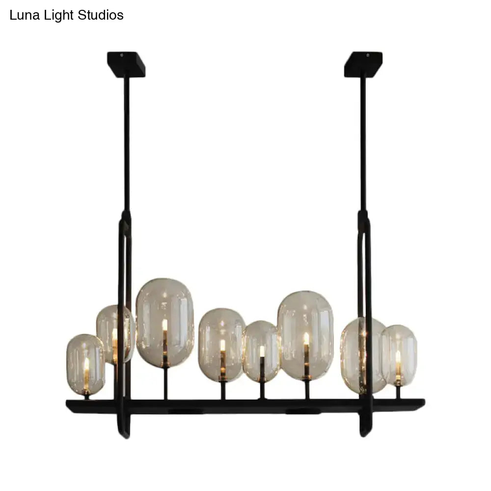 Modern black metal chandelier with frosted glass globes featuring adjustable chain cord length and fixture height for industrial lighting