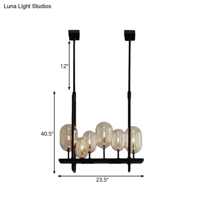 Black metal chandelier with five amber glass globe shades featuring adjustable chain cord length and fixture height