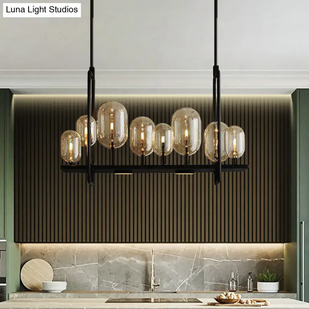 Modern black metal chandelier with amber glass globe shades featuring adjustable chain cord length and fixture height