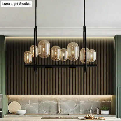 Modern black metal chandelier with amber glass globe shades featuring adjustable chain cord length and fixture height