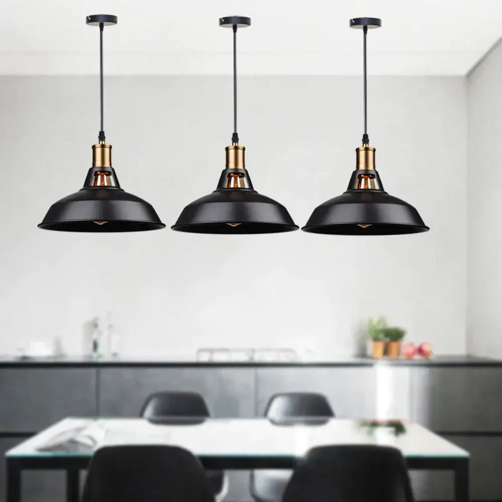 Three black and brass industrial farmhouse pendant lights hang above a dining table decorbites industrial farmhouse decor
