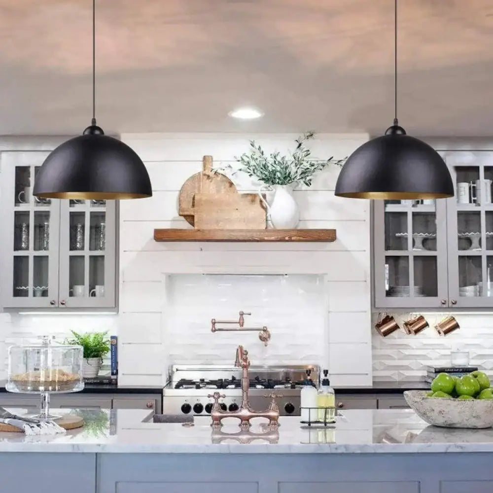Industrial black and gold metal cage pendant light with black metal cage and gold interiors above a kitchen island