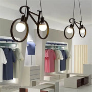 Industrial black bicycle pendant light with circular frame and exposed bulb fixture for living room decorbites industrial bicycle decor