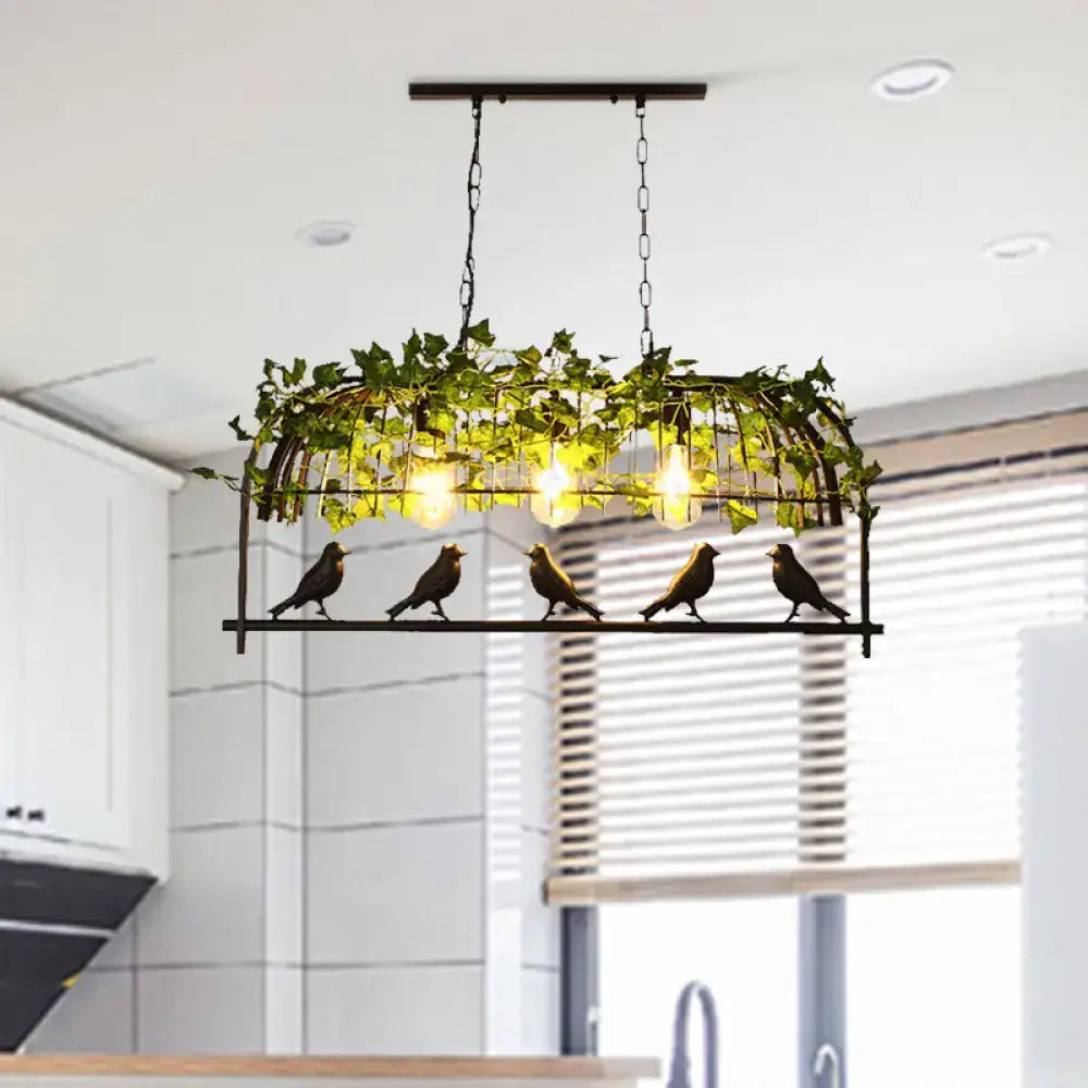 Industrial black metal bird-themed pendant light with warm e26 e27 bulb base and green ivy plant decoration