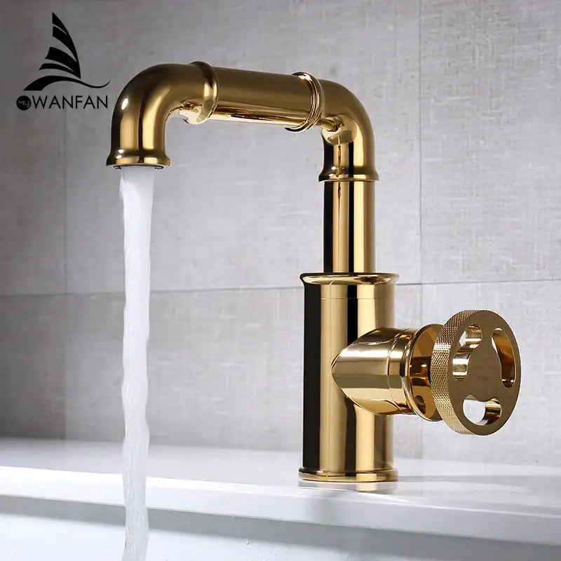 Gold-finished black brass basin faucet with vintage industrial design and large textured circular handle by decorbites