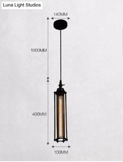 Industrial black and brass flute pendant light with cylindrical glass and exposed filament bulb for kitchen island lighting