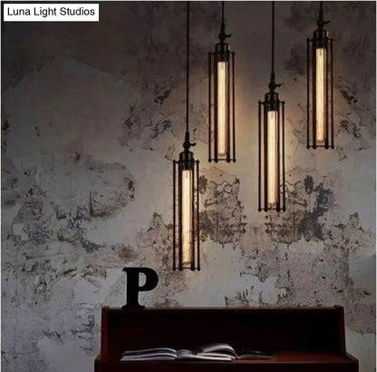 Industrial black and brass flute pendant light with black metal frame and glowing filament bulbs for kitchen island