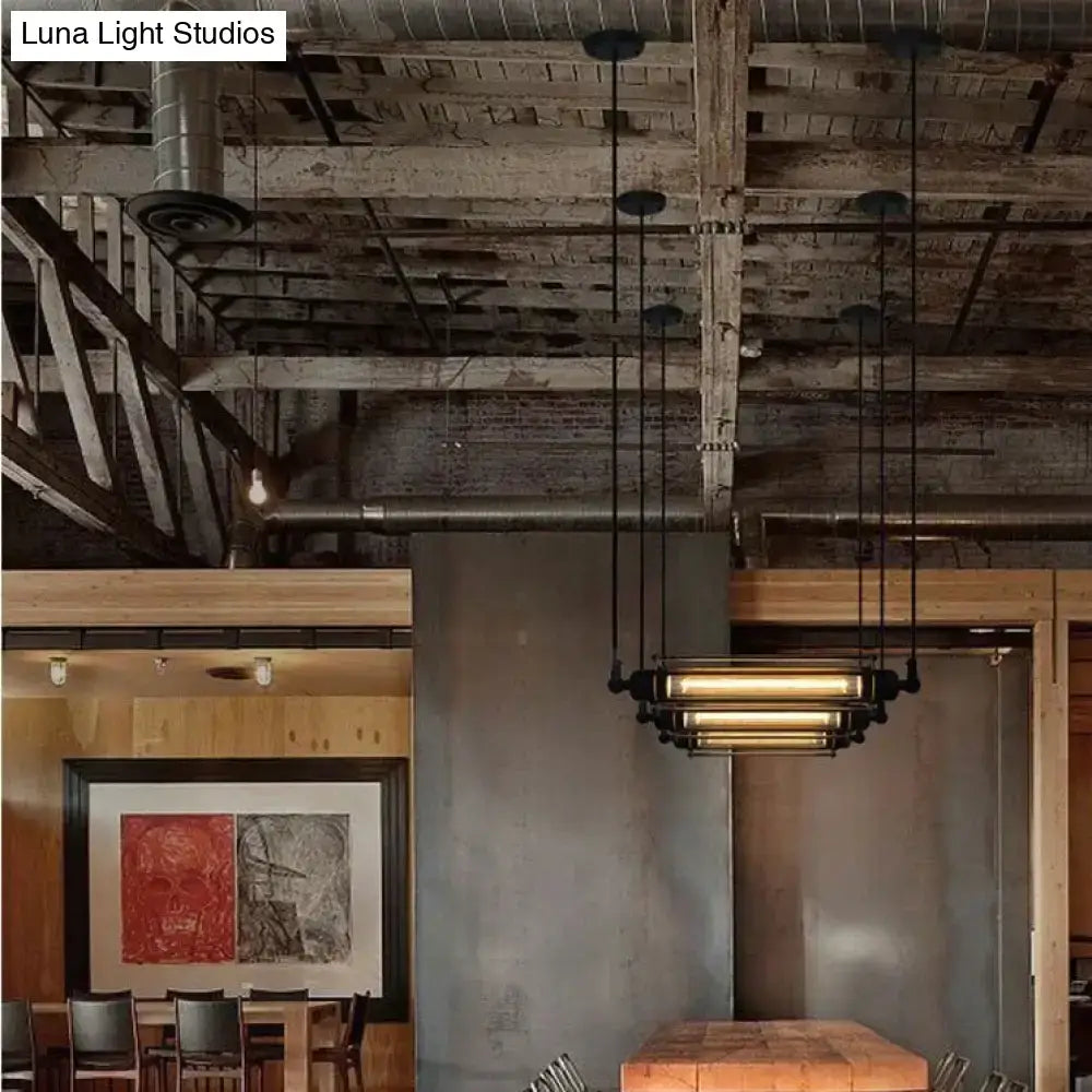 Industrial black and brass flute pendant light with metal frame featuring multiple horizontal tubes for kitchen island