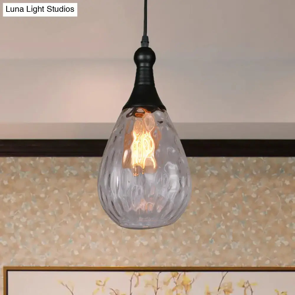 A clear textured glass ceiling light with black metal fixture and exposed filament bulb daisy industrial black brass