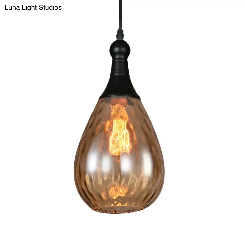 A teardrop amber glass ceiling light with black metal fixture and exposed filament bulb from decorbites daisy industrial black brass