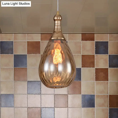 A daisy industrial black ceiling light with a brass teardrop amber glass shade and exposed filament bulb