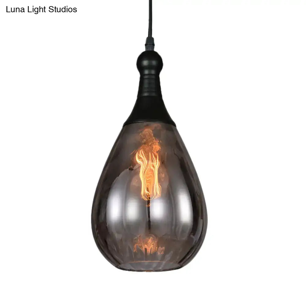 A daisy industrial black brass ceiling light with a sleek teardrop smoked glass shade and exposed filament bulb
