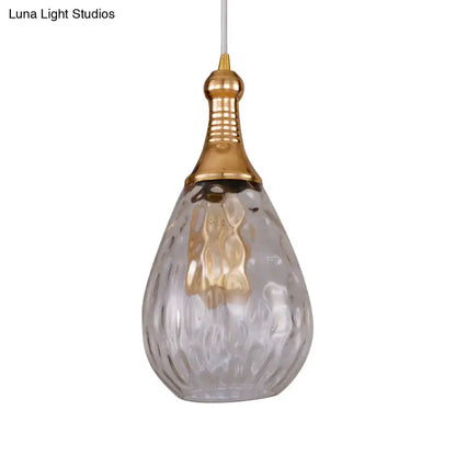 A teardrop ceiling light with textured glass and polished gold-toned top for daisy industrial black brass decor
