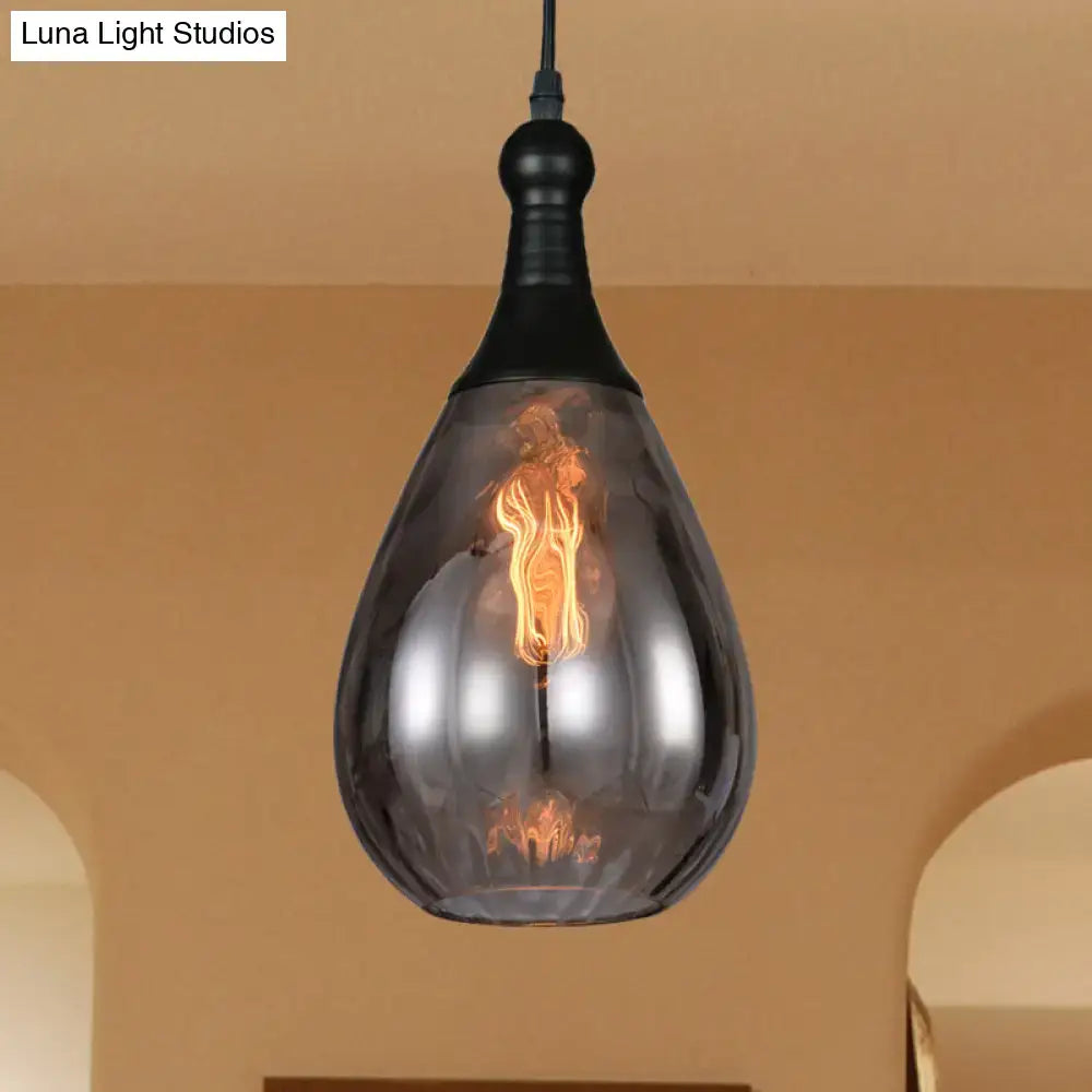 A sleek decorbites daisy industrial black brass ceiling light with smoked glass shade and exposed filament bulb