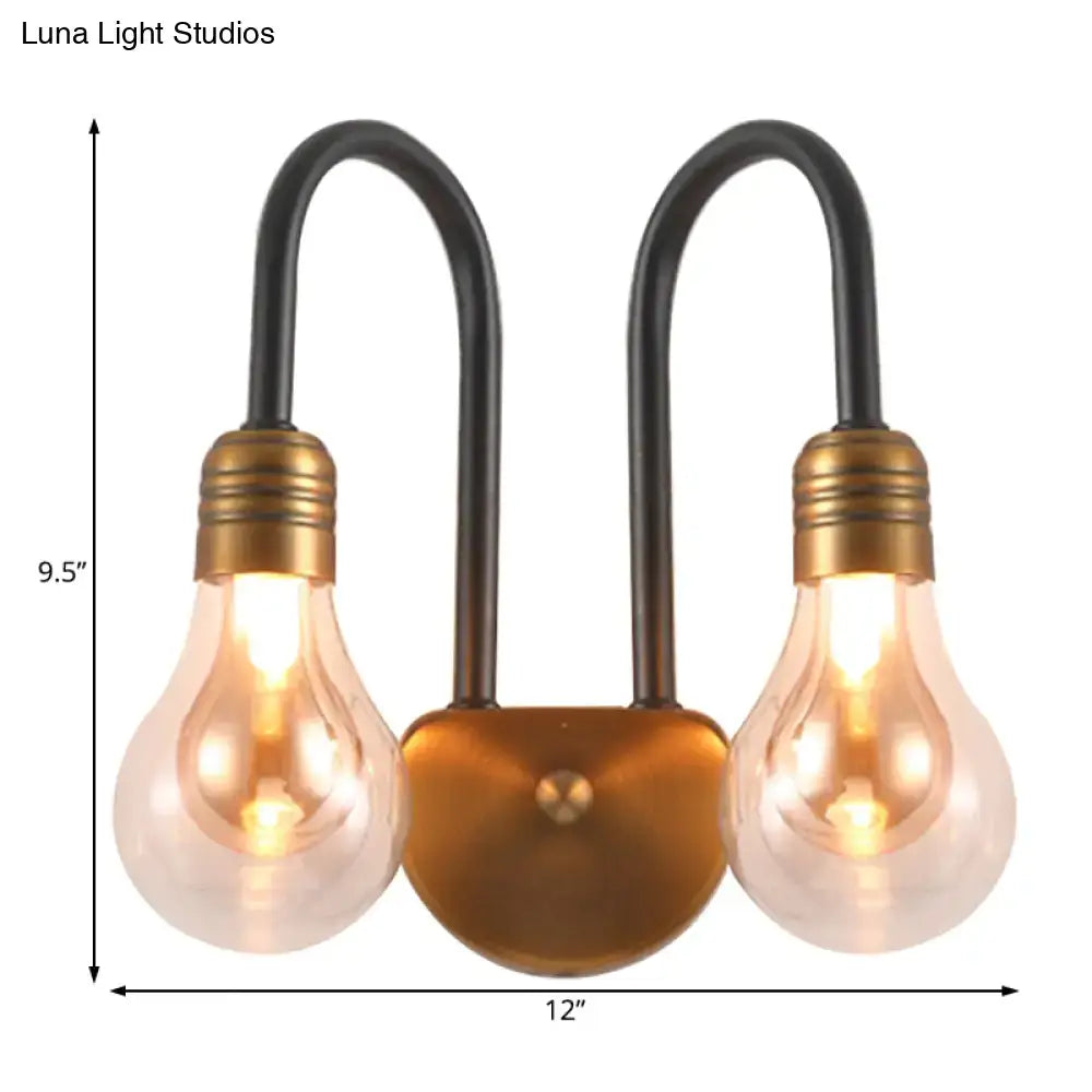 Industrial black and brass wall lamp with two exposed edison bulbs and brushed brass fixture width for bedroom lighting