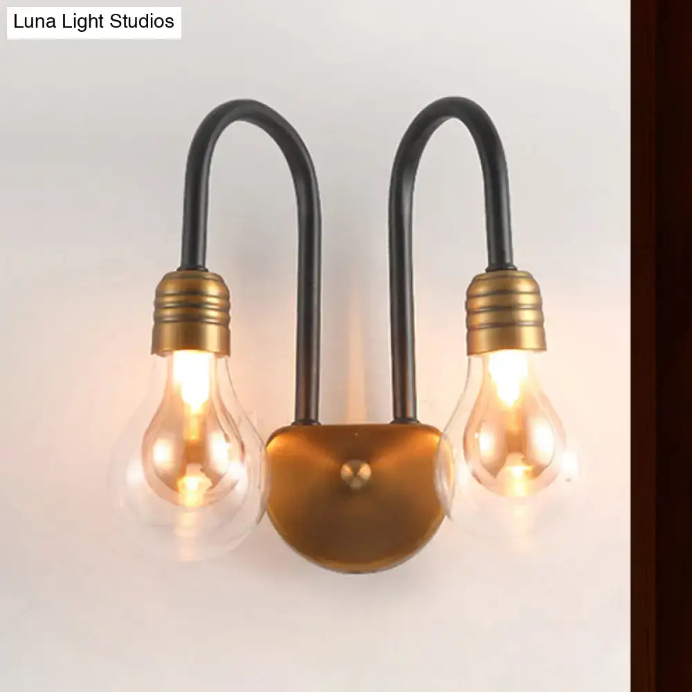 Industrial black and brass wall lamp with two arched arms and brass bulb sockets, ideal bedroom led light fixture