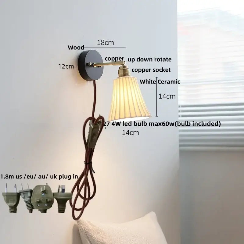 Industrial black and brass wall light fixture with black wooden base, copper arm, white pleated ceramic shade, and brown cord