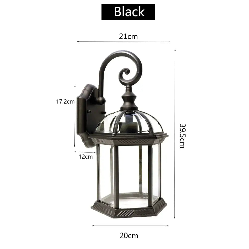 Black wrought iron wall lamp with clear glass panels and decorative curved arm decorbites black bronze wall lantern