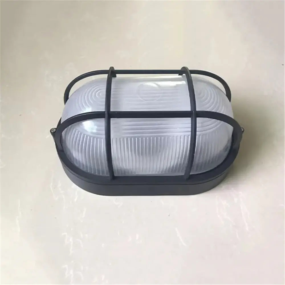Industrial black bulkhead wall light with metal cage and frosted ribbed glass lens for outdoor security decorbites wall light