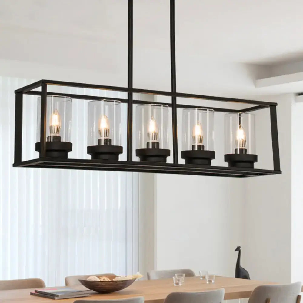 Black metal rectangular chandelier with five clear glass cylinders and exposed filament bulbs for kitchen island lighting