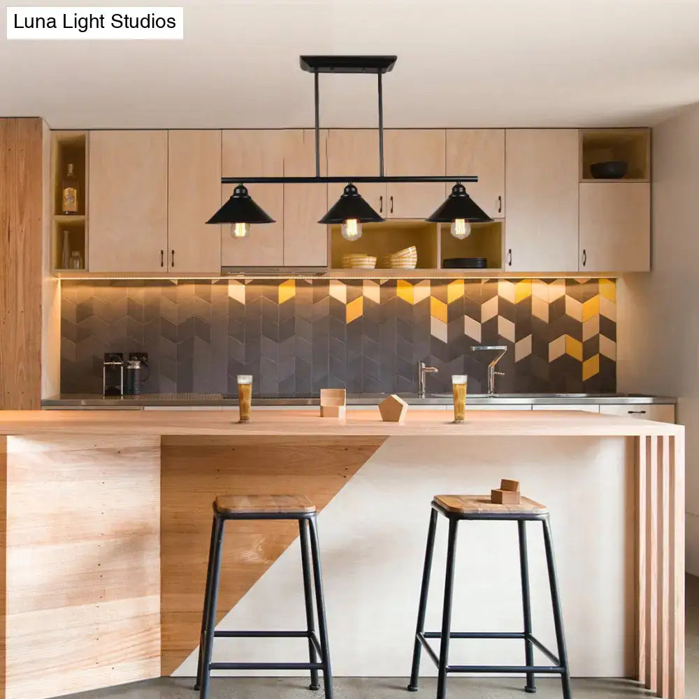 Black metal island pendant light fixture with three conical shades suspended above wooden kitchen island
