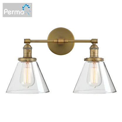 Industrial black wall sconce with permob brass finish and double cone glass shades featuring exposed filament bulbs