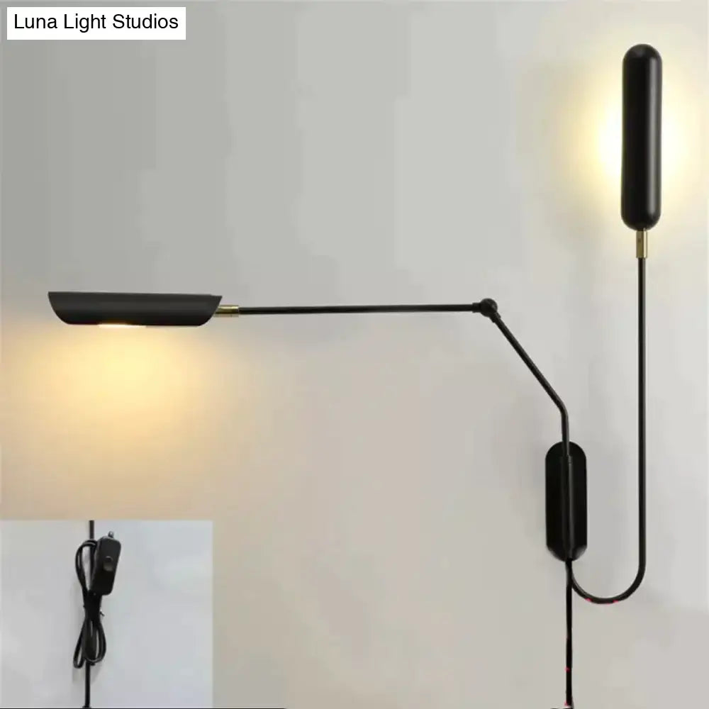 Black adjustable emma industrial wall lamp with brass accents for modern bedroom reading light use