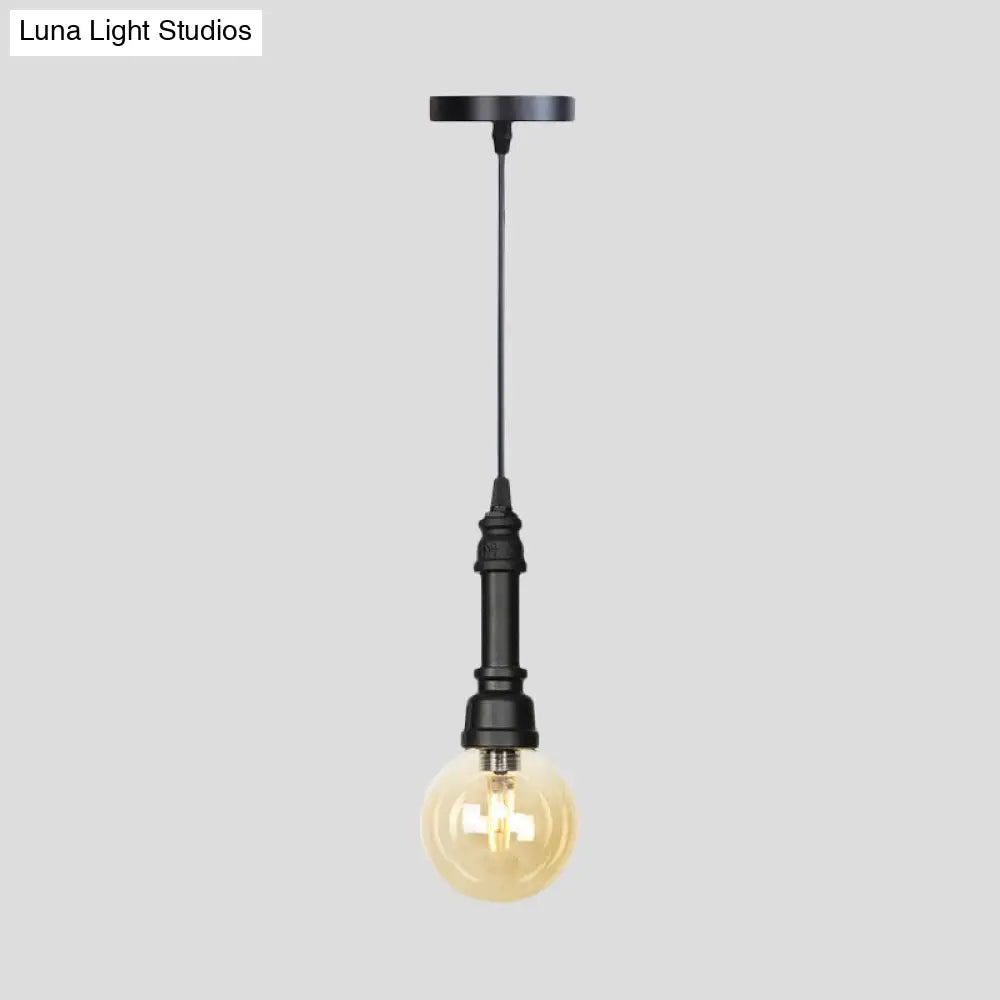 Industrial Black Finish Amber Glass Pendant Lamp with Pipe Suspension - 1-Light Ball/Capsule Ceiling Light