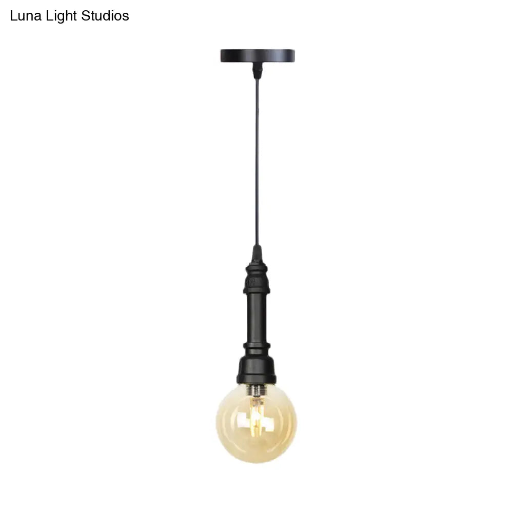 Industrial Black Finish Amber Glass Pendant Lamp with Pipe Suspension - 1-Light Ball/Capsule Ceiling Light