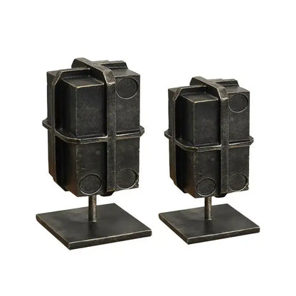 Industrial black geometric block binding metal bookends with rugged textured finish and circular cutouts for living room use