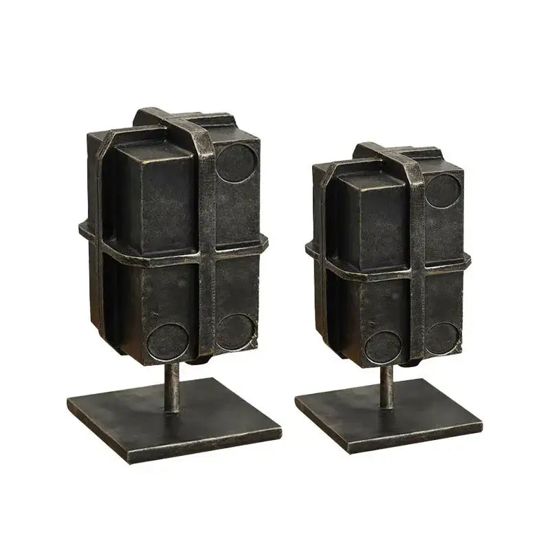 Industrial black geometric block binding metal bookends with rugged textured finish and circular cutouts for living room use