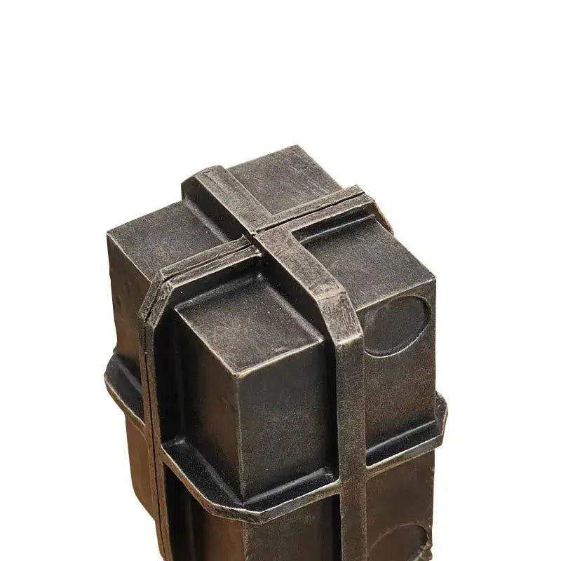 Industrial black geometric block binding metal bookends featuring a dark metallic puzzle box with interlocking cubes and circular cutouts