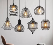 Black wrought iron pendant light with geometric cage light frame and exposed filament bulbs for dining room decorbites cage light