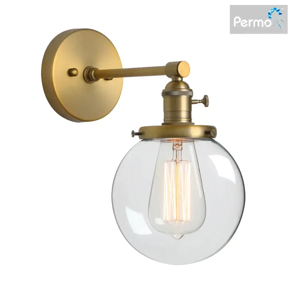 Brass-finished industrial glass canopy wall sconce with clear glass globe and exposed filament bulb for kitchen decorbites industrial glass