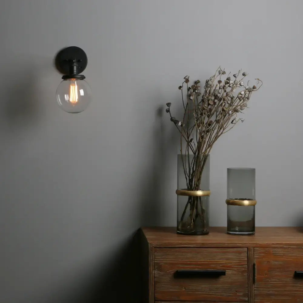 Industrial black glass canopy wall sconce with clear glass globe and exposed filament bulb for kitchen decorbites industrial glass